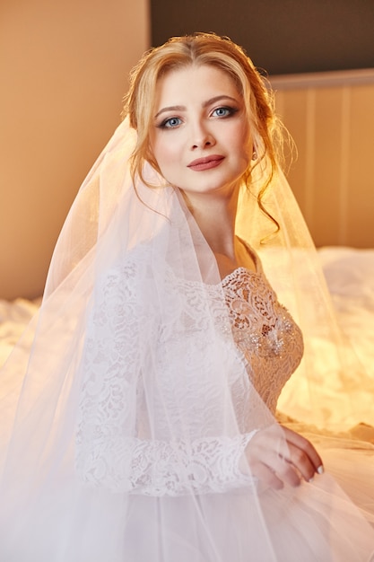 Portrait of a bride sitting in a chic white dress