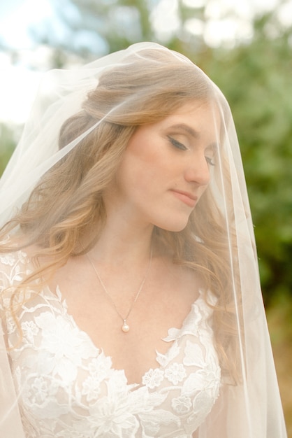 Portrait of a bride in tulle in the park