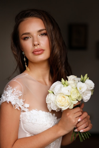 Portrait of the bride with flowers bouquet