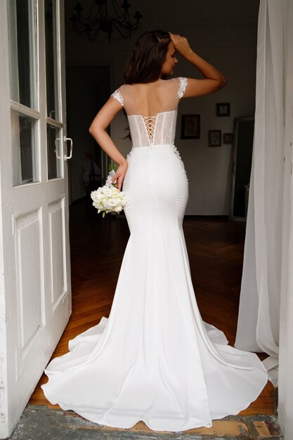 Portrait of the bride with flowers bouquet