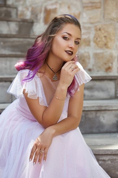 Photo portrait of a bride with purple hair close-up. a woman in a beautiful dress is resting