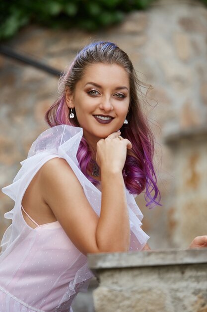 Portrait of a bride with purple hair close-up