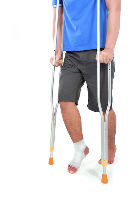 Portrait of a broken foot using crutch