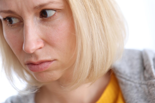 Portrait of a brooding woman on a white background