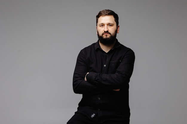 portrait of brunette bearded man on white background