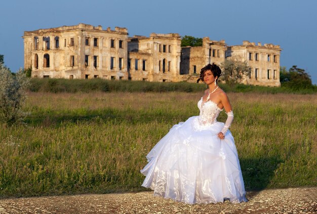 Portrait of brunette bride with the ruins on the background