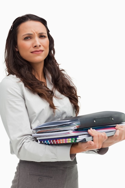 Portrait of a brunette carrying heavy files 