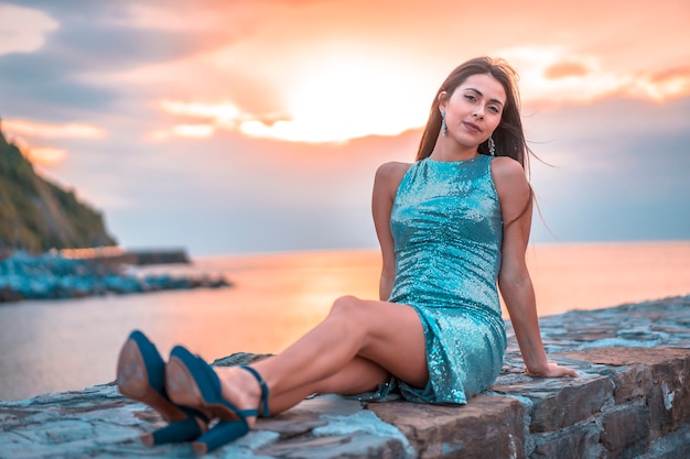 Portrait of brunette caucasica in an orange and cloudy sunset