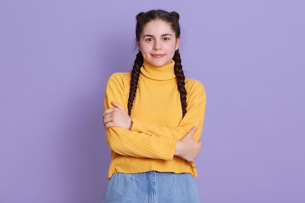 Portrait of brunette female with creative braid hairdo