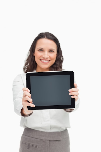 Portrait of a brunette showing a touchpad screen