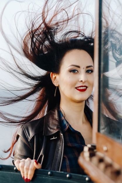 Portrait of a brunette with flying hair in the wind