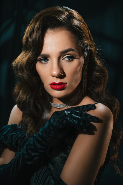 Portrait of a brunette woman in a classic retro style A beautiful girl with a hairstyle and makeup with jewelry Hollywood film