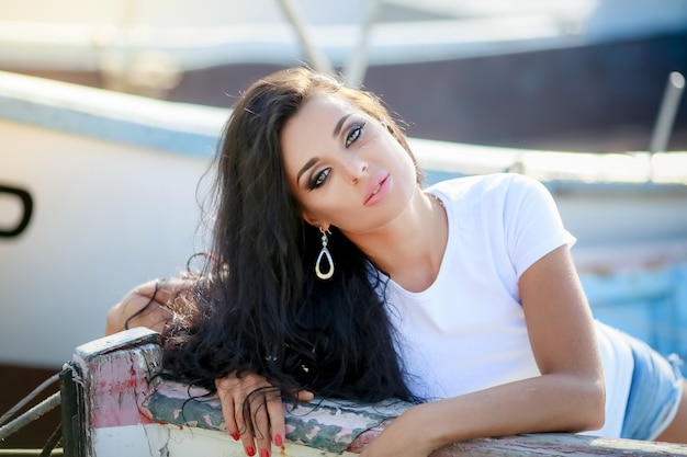 Portrait of a brunette woman leaning on the side of a small tourist boat