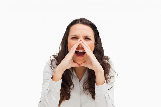 Portrait of a brunette yelling with hands