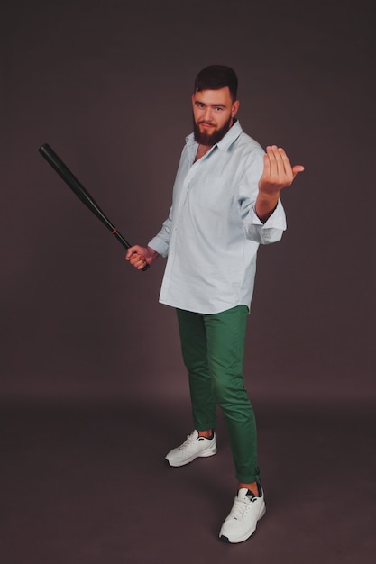 Portrait of brutal, bearded, aggressive, big person with baseball bat in hand