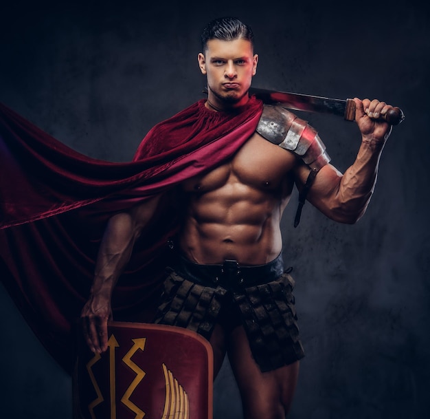 Portrait of a brutal Roman legionary in battle uniforms on a dark background.