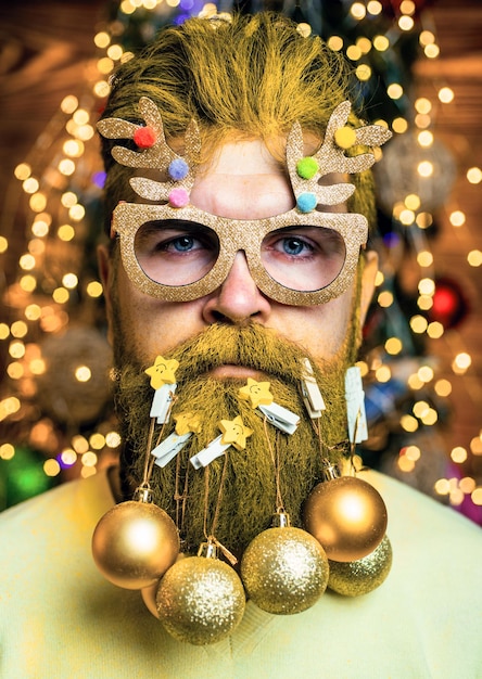 Portrait of a brutal santa claus beard with bauble santa in barber shop christmas style for modern s...