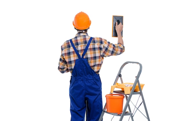 Portrait of a builder in a helmet with tools