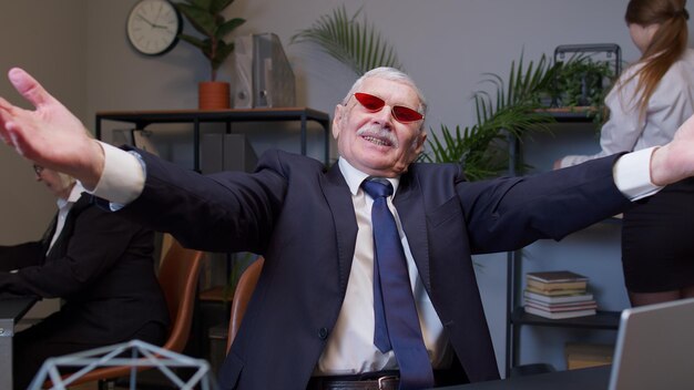 Portrait of business colleagues stacking hands in office