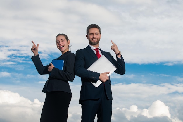 Portrait of a business couple with pointing finger young confident businesspeople secretary and boss