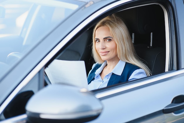 Portrait of business elegant middleaged woman in car