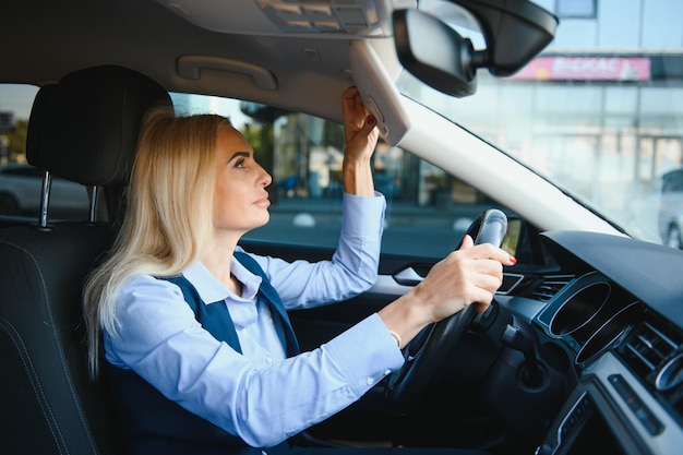 Portrait of business elegant middleaged woman in car