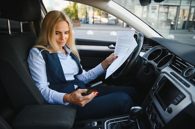 Portrait of business elegant middleaged woman in car