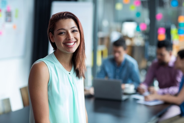 Portrait of business executive standing in office