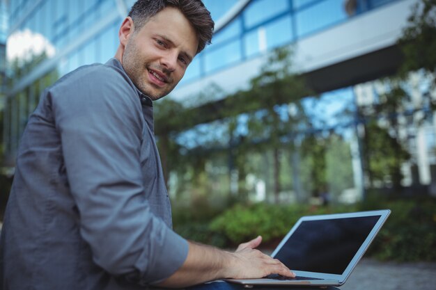 Portrait of business executive using laptop