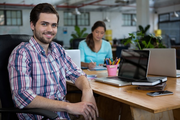 Portrait of business executive working on desk in office