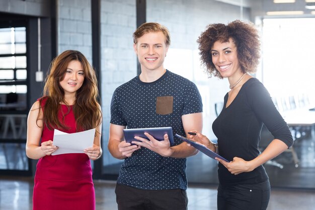 Portrait of business  executives standing together and smiling in office