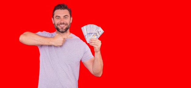 Portrait business man holding cash dollar bills over red studio background big luck banner dollar ca