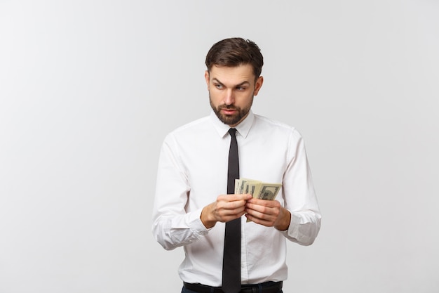 Portrait of a business man holding money, isolated on white.