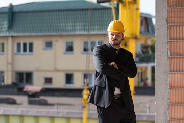 Portrait Of Business Man With Yellow Helmet On Construction