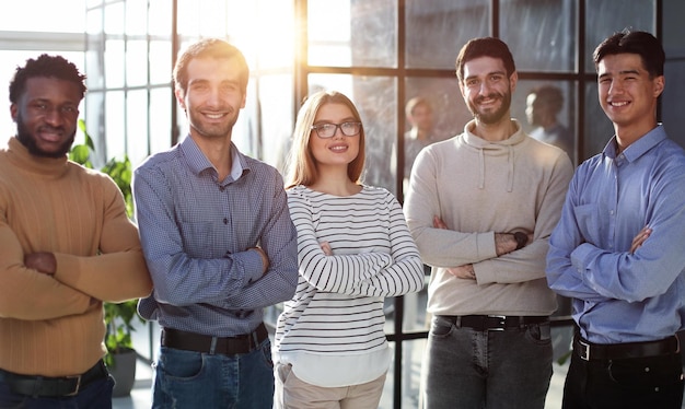 portrait of business people in casual clothes standing with their arms crossed