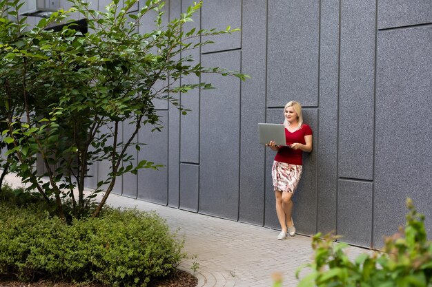 Portrait of a business woman holding laptop computer