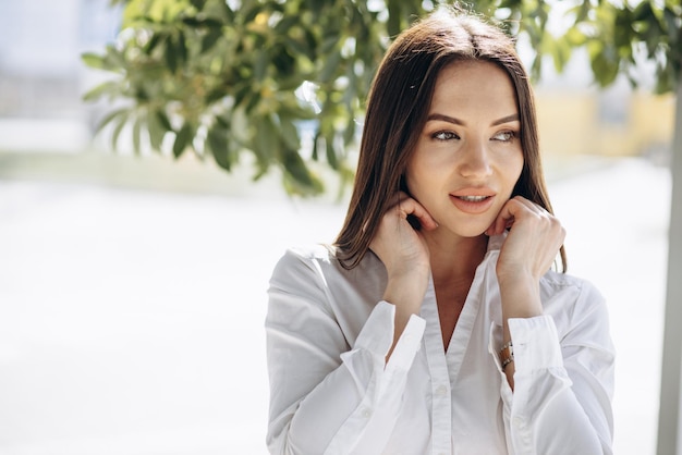 Portrait of business woman in white shirt standing in office