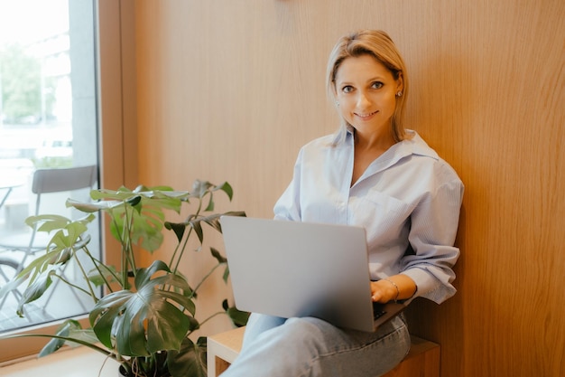 Portrait of a business woman in with a laptop Casual older woman with a modern laptop