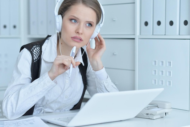 Portrait of a business woman with a laptop in the office