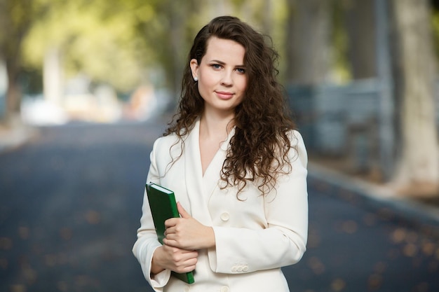 Portrait of a business woman with a notebook in her hand.