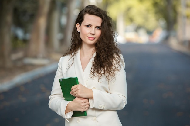 Portrait of a business woman with a notebook in her hand.