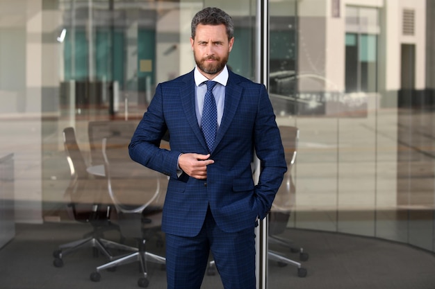 Portrait of businessman in front of modern office