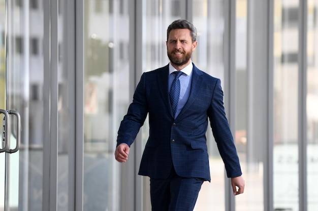 Portrait of businessman in front of modern office