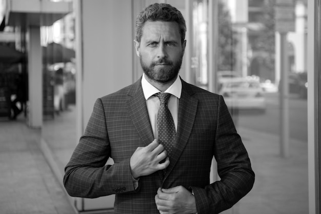 Portrait of businessman in front of modern office