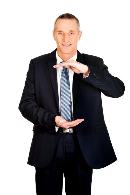 Portrait of businessman gesturing against white background