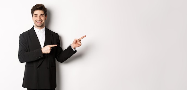 Portrait of businessman gesturing while standing against white background