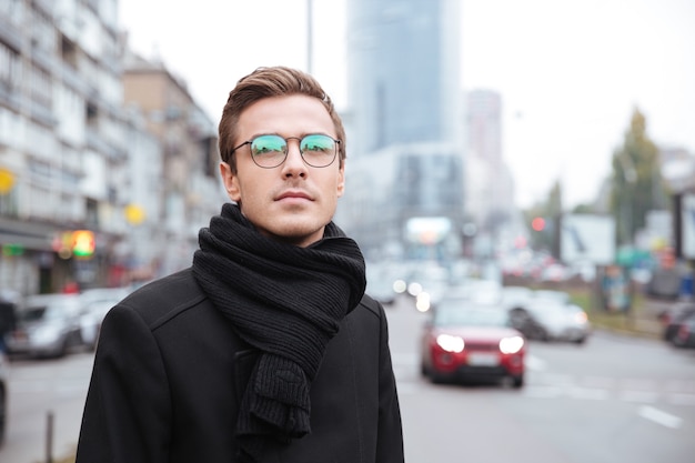 Portrait of Businessman in glasses in the street.