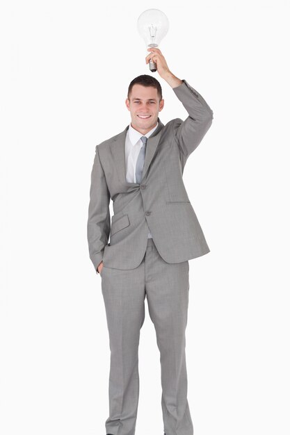 Portrait of a businessman holding a bulb above his head