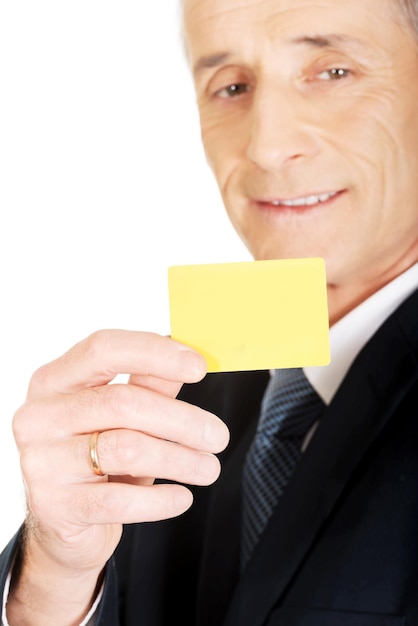 Photo portrait of businessman holding business card against white background