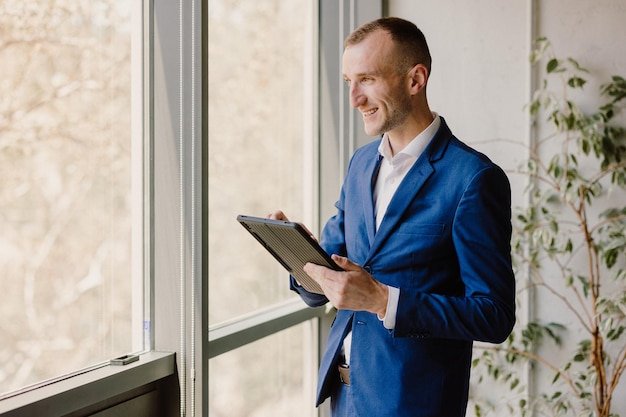 Portrait of a businessman holding a tablet